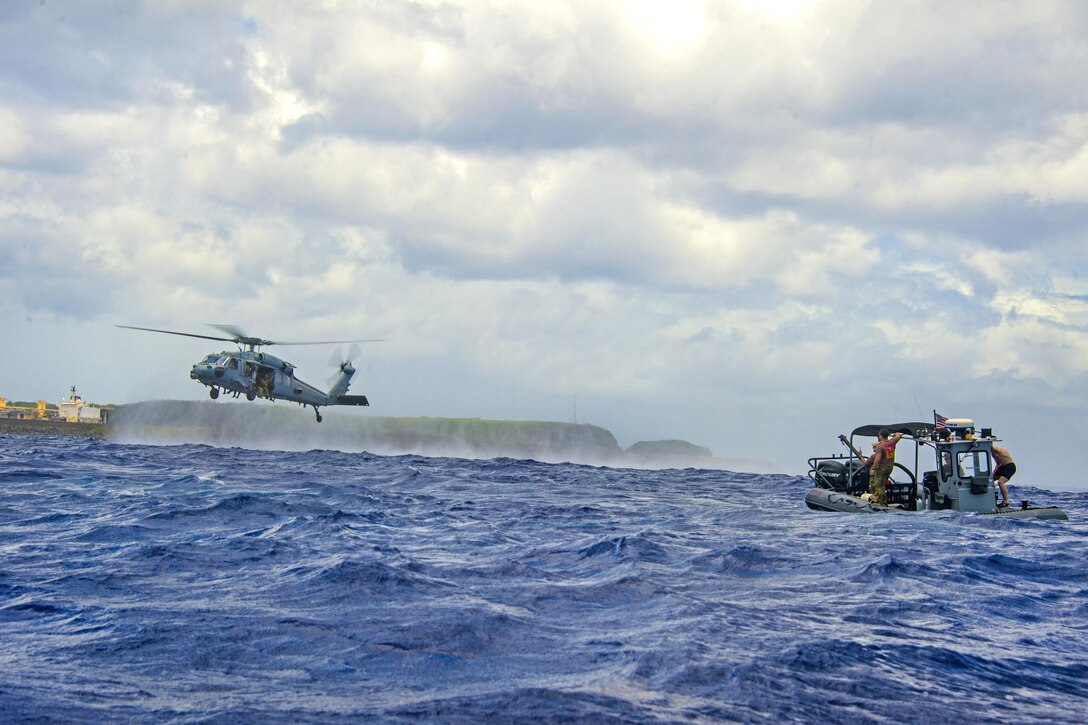 U.S. sailors, and Australian navy clearance divers participate in mine countermeasure pouncer procedures during Exercise Tricrab off the coast of Guam, May 10, 2016. Navy photo by Petty Officer 3rd Class Alfred A. Coffield