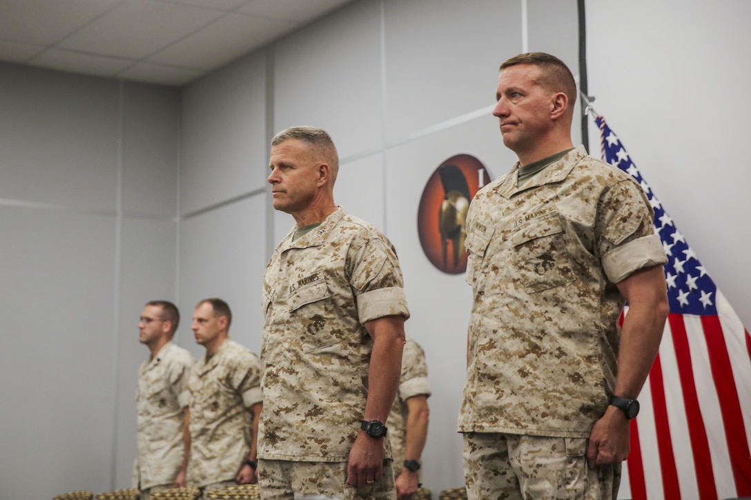 Maj. Gen. Lewis A. Craparotta, Combat Center Commanding General, and Col. Craig R. Wonson, commanding officer, Marine Corps Tactics and Operations Group, stand at the position of attention during the playing of the national anthem during the graduation ceremony for Tactical Marine Air Ground Task Force Integration Course 1-16 aboard the Combat Center May 6, 2016. (Official Marine Corps photo by Lance Cpl. Levi Schultz/Released)