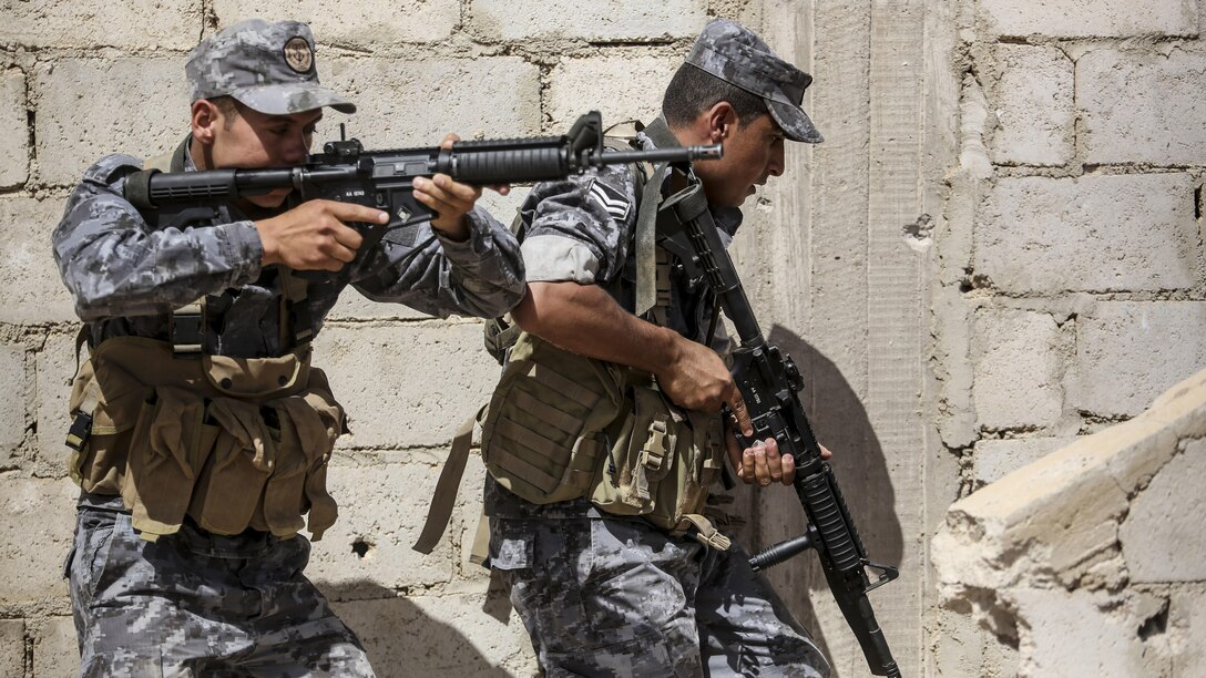 Members of the Jordanian 77th Marines Battalion prepare to clear a room during a military operation in urban terrain tactics exercise in Al Quweyrah, Jordan, May 16, 2016. Eager Lion is a recurring exercise between partner nations designed to strengthen military-to-military relationships, increase interoperability, and enhance regional security and stability. 