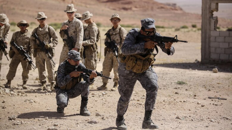 Members of the Jordanian 77th Marines Battalion advance to clear a room during a military operations in urban terrain tactics exercise in Al Quweyrah, Jordan, May 16, 2016. Eager Lion is a recurring exercise between partner nations designed to strengthen military-to-military relationships, increase interoperability, and enhance regional security and stability. 
