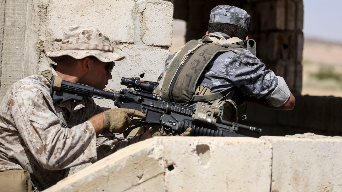A member of the Jordanian 77th Marines Battalion, and a Marine with 1st Battalion, 2nd Marine Regiment, 2nd Marine Division, clear a room during a military operations in urban terrain tactics exercise in Al Quweyrah, Jordan, May 16, 2016. Eager Lion is a recurring exercise between partner nations designed to strengthen military-to-military relationships, increase interoperability, and enhance regional security and stability.
