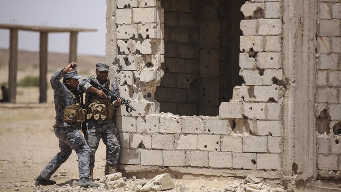 A member of the Jordanian 77th Marines Battalion tosses a training grenade during a military operation in urban terrain tactics exercise in Al Quweyrah, Jordan, May 16, 2016. Eager Lion is a recurring exercise between partner nations designed to strengthen military-to-military relationships, increase interoperability, and enhance regional security and stability.