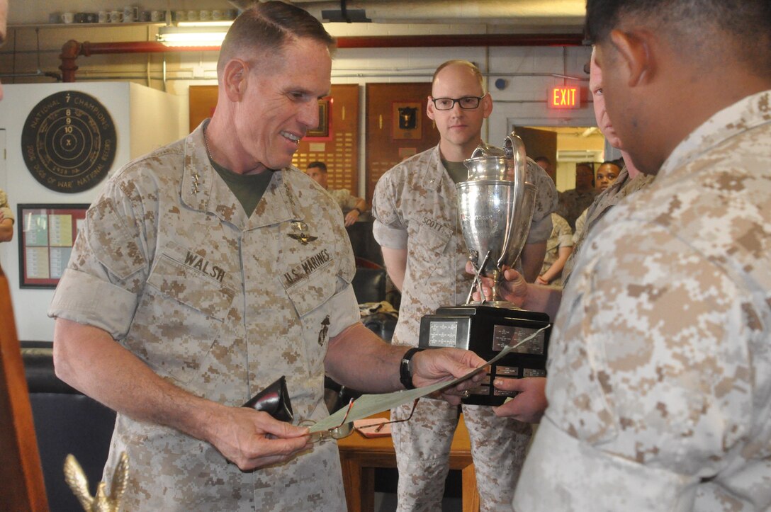 Lt. Gen. Robert Walsh looks over an official scorecard that helped to win the championship. Next to him is Lt. Col. Daniel Scott.