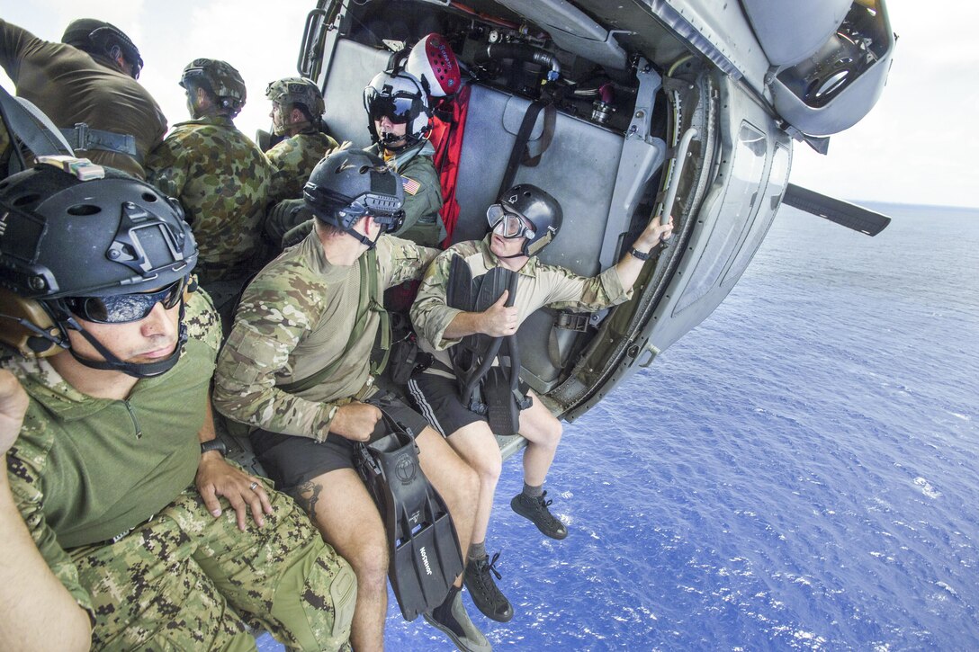U.S. and Australian sailors prepare to fast-rope from an MH-60S Seahawk helicopter during Exercise Tricrab off the coast of Guam, May 10, 2016. Navy photo by Petty Officer 1st Class Doug Harvey
