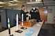 Various heritage pieces are stored in the new Global Strike Research Facility. AFGSC Command Historian Yancy Mailes, displayed many of these pieces shortly after the ribbon-cutting ceremony. Staff can check these items out for command events (Air Force Photo by TSgt. Ave Young, Air Force Global Strike Command Public Affairs).