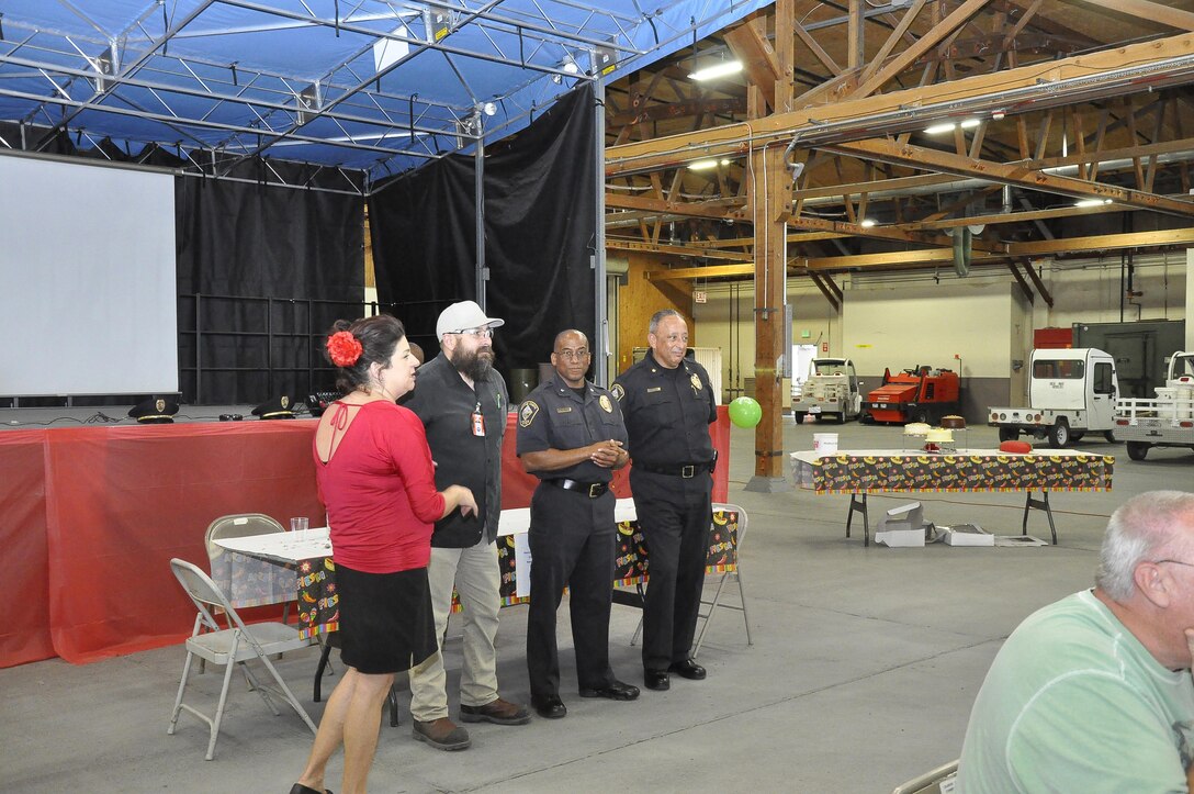 Samantha Atkinson, Management and Program assistant with Fleet Support division aboard Marine Corps Logistics Base Barstow's Yermo Annex, introduces the judges for the FSD annual chili cookoff, May 5. Left to right: Samantha Atkinson, with ERC at FSD; Roland Gonzalez, trades branch head with Production Plant Barstow; Darwin O'Neal, chief of police with Marine Corps Police Department on MCLBB; William Atkinson, deputy chief of police with MCPD on MCLBB.   