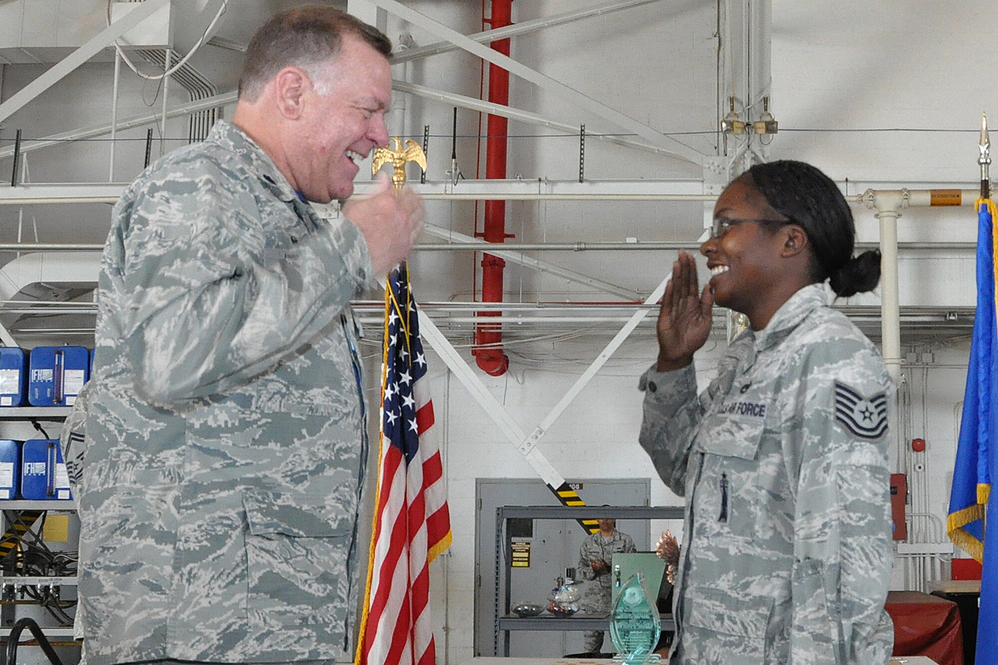 U.S. Air Force Lt. Col. Leo Kamphaus, 307th Maintenance Group commander, congratulates Tech. Sgt. Holly Guerra for being awarded an associates degree through the Community College of the Air Force during a Commander’s Call on May 15, 2016, Barksdale Air Force Base, La. Guerra was awarded a degree in Aircraft Armament Systems Technology. (U.S. Air Force photo by Master Sgt. Greg Steele/Released)