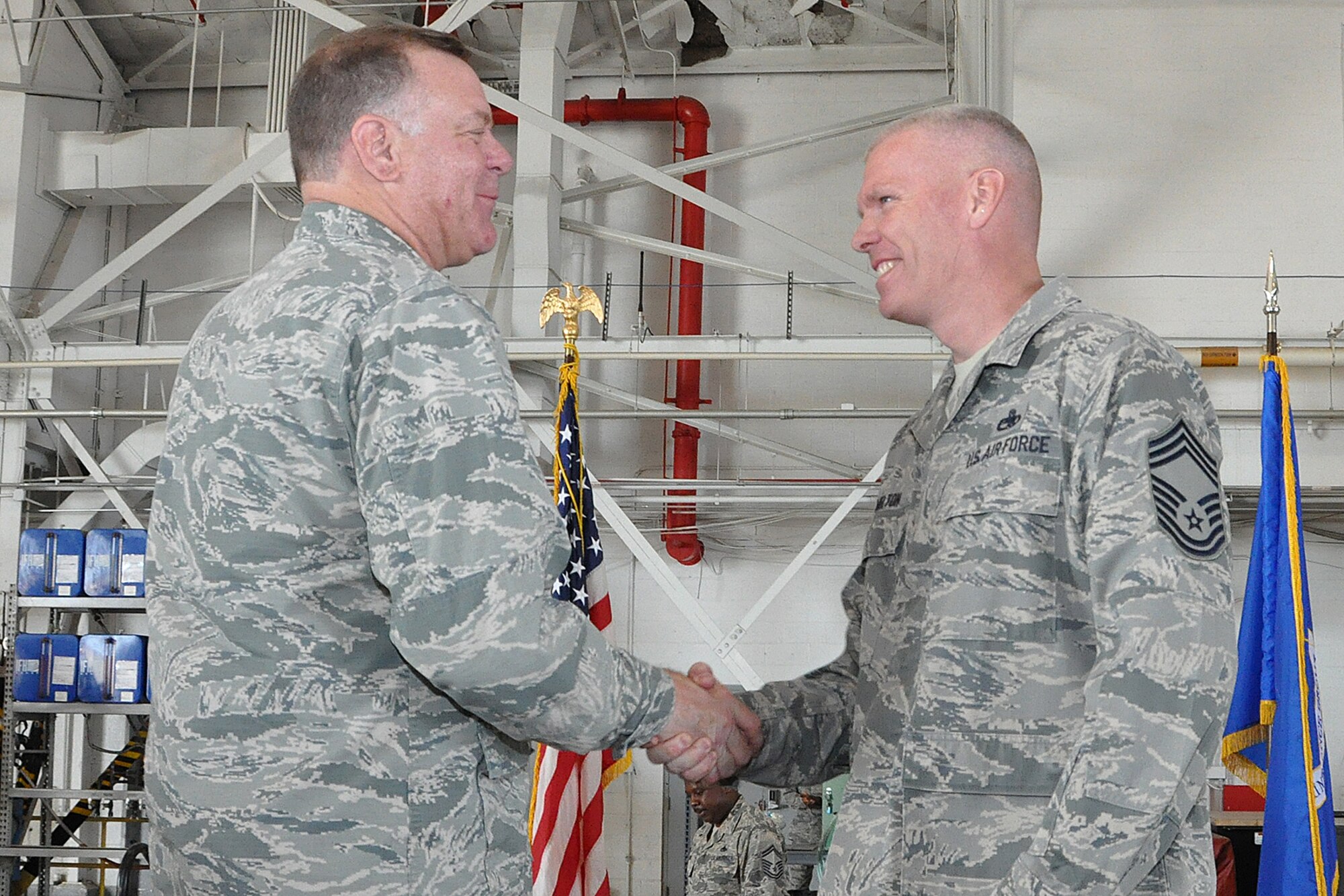 U.S. Air Force Lt. Col. Leo Kamphaus, 307th Maintenance Group commander, congratulates Chief Master Sgt. Ty Melton for being awarded an associates degree through the Community College of the Air Force during a Commander’s Call on May 15, 2016, Barksdale Air Force Base, La. Melton was awarded a degree in Munitions Systems Technology. (U.S. Air Force photo by Master Sgt. Greg Steele/Released)