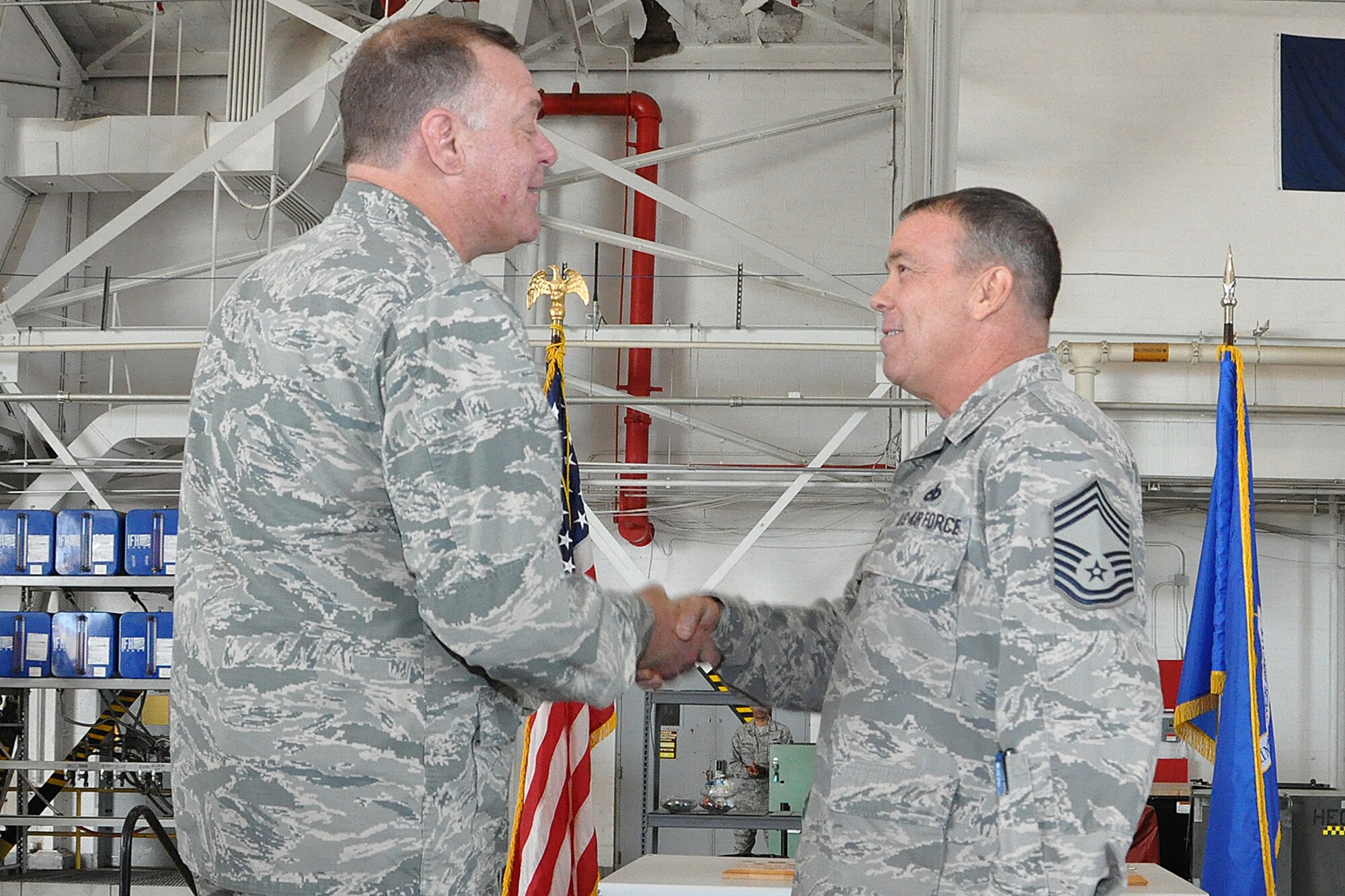 U.S. Air Force Lt. Col. Leo Kamphaus, 307th Maintenance Group commander, congratulates Chief Master Sgt. Philip Weber for being awarded an associates degree through the Community College of the Air Force during a Commander’s Call on May 15, 2016, Barksdale Air Force Base, La. Weber was awarded a degree in Munitions Systems Technology. (U.S. Air Force photo by Master Sgt. Greg Steele/Released)