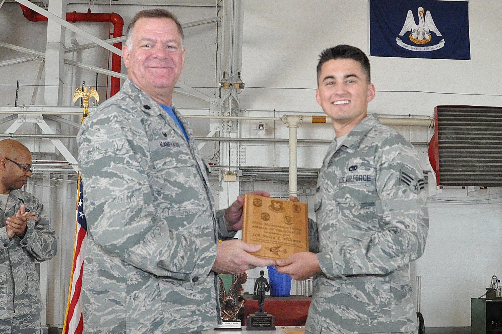 U.S. Air Force Lt. Col. Leo Kamphaus, 307th Maintenance Group (MXG) commander, presents an award to Senior Airman Nolan Willmon during a Commander’s Call on May 15, 2016, Barksdale Air Force Base, La. Willmon is assigned to the 307th Maintenance Squadron and was selected as the 307th MXG Airman of the Quarter for the first quarter of 2016. (U.S. Air Force photo by Master Sgt. Greg Steele/Released)