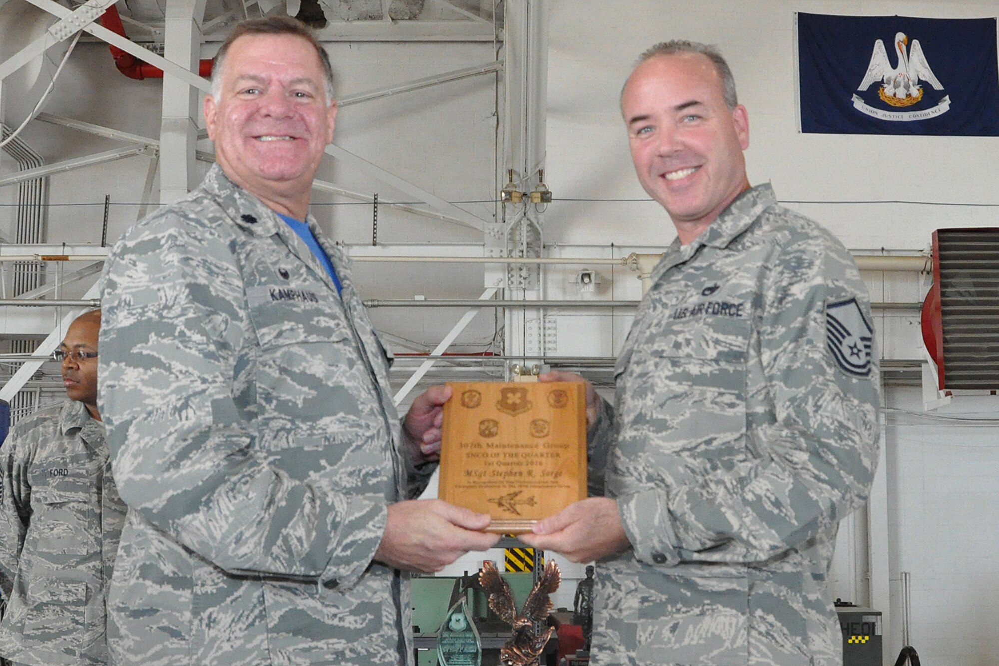 U.S. Air Force Lt. Col. Leo Kamphaus, 307th Maintenance Group (MXG) commander, presents an award to Master Sgt. Stephen Sorge during a Commander’s Call on May 15, 2016, Barksdale Air Force Base, La. Sorge is assigned to the 307th Maintenance Squadron and was selected as the 307th MXG Senior Non-Commissioned Officer of the Quarter for the first quarter of 2016. (U.S. Air Force photo by Master Sgt. Greg Steele/Released)