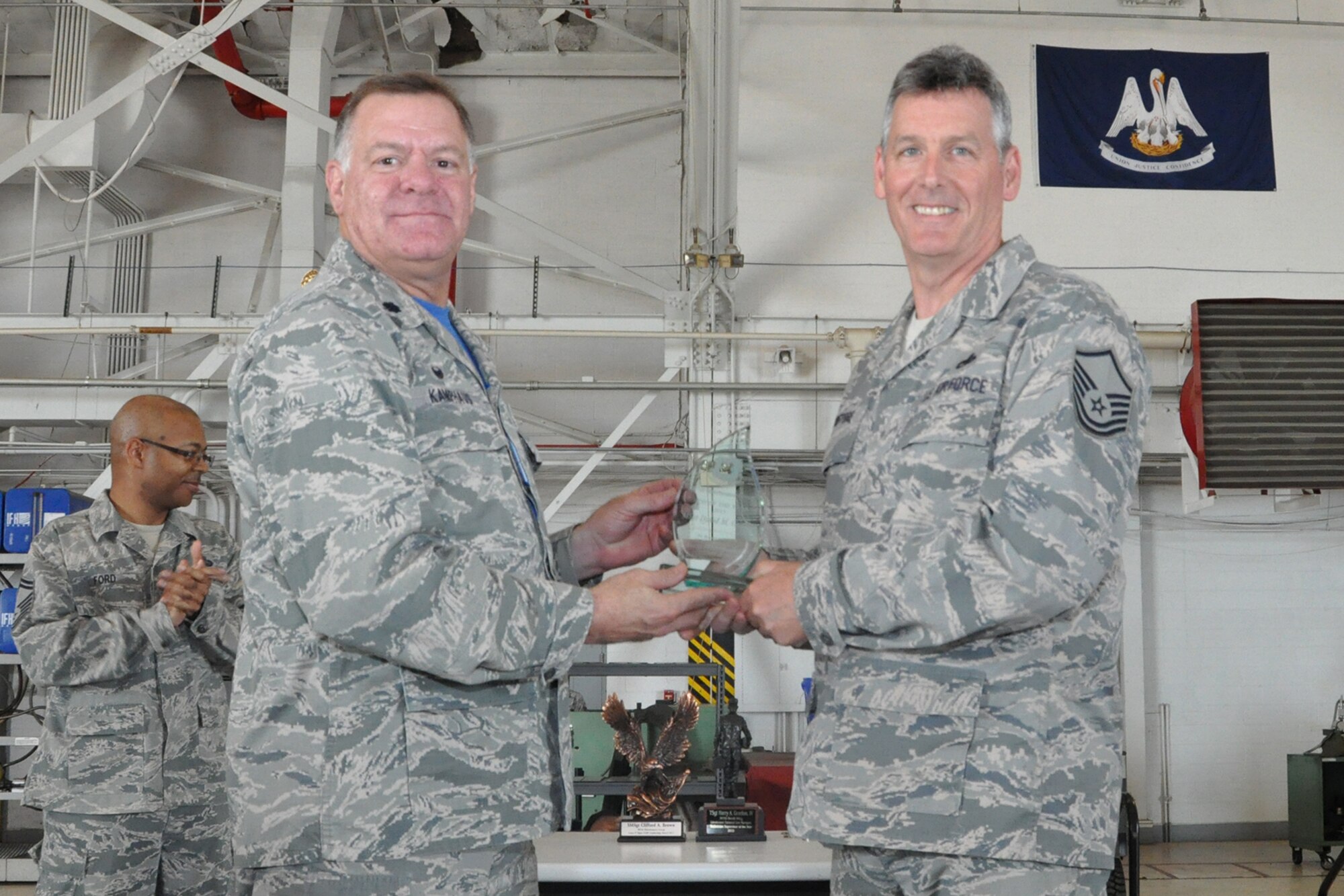 U.S. Air Force Lt. Col. Leo Kamphaus, 307th Maintenance Group (MXG) commander, presents an award to Master Sgt. David Griffore during a Commander’s Call on May 15, 2016, Barksdale Air Force Base, La. Griffore is assigned to the 307th Maintenance Squadron and was selected as the 307th MXG Non-Commissioned Officer of the Year for 2015. (U.S. Air Force photo by Master Sgt. Greg Steele/Released)
