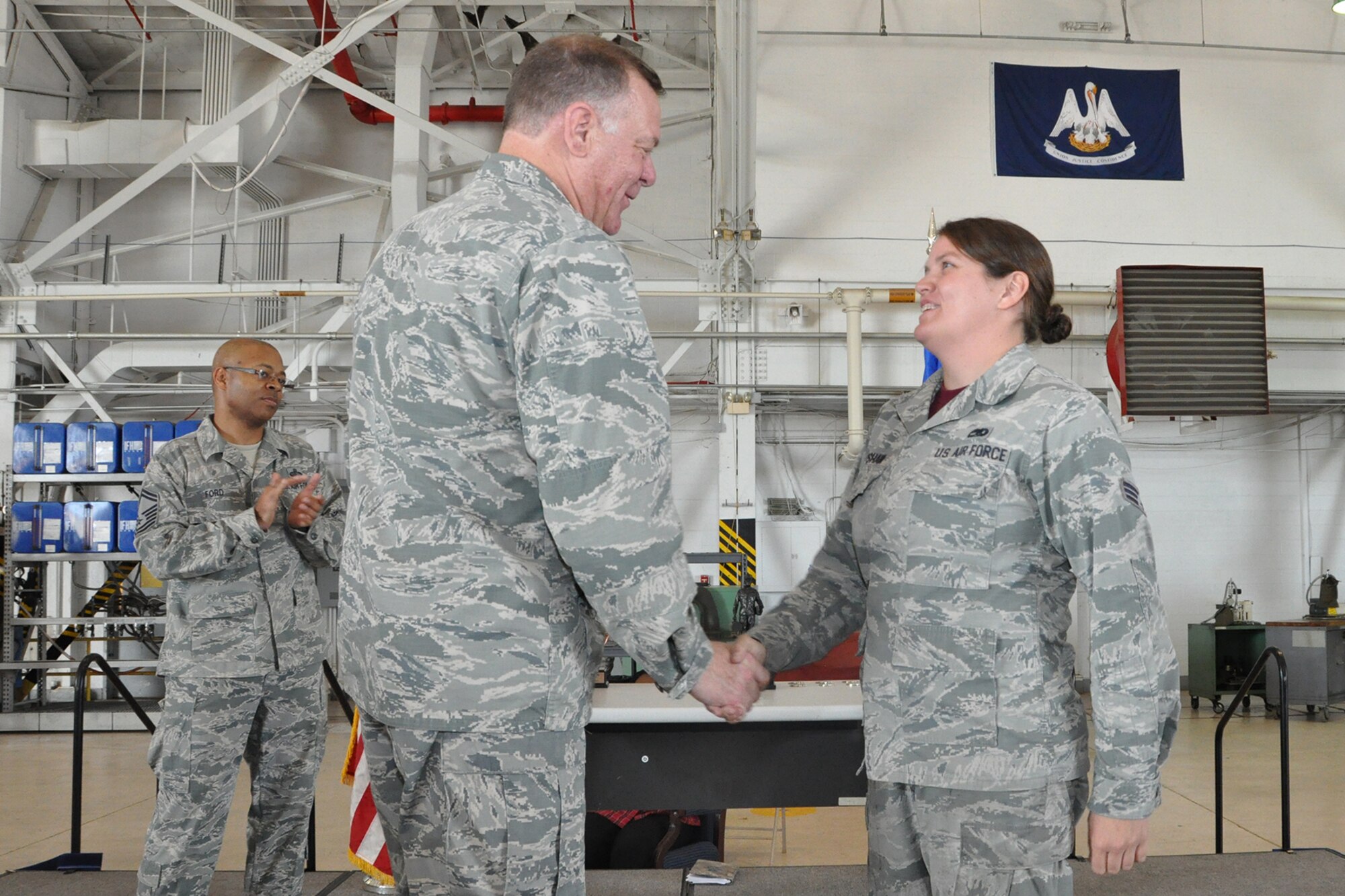 U.S. Air Force Lt. Col. Leo Kamphaus, 307th Maintenance Group commander, congratulates Senior Airman Rachel Upshaw during a Commander’s Call on May 15, 2016, Barksdale Air Force Base, La. Upshaw is assigned to the 707th Maintenance Squadron and was awarded the Chief Master Sergeant Thomas N. Barnes Award for the most outstanding crew chief in the wing. (U.S. Air Force photo by Master Sgt. Greg Steele/Released)