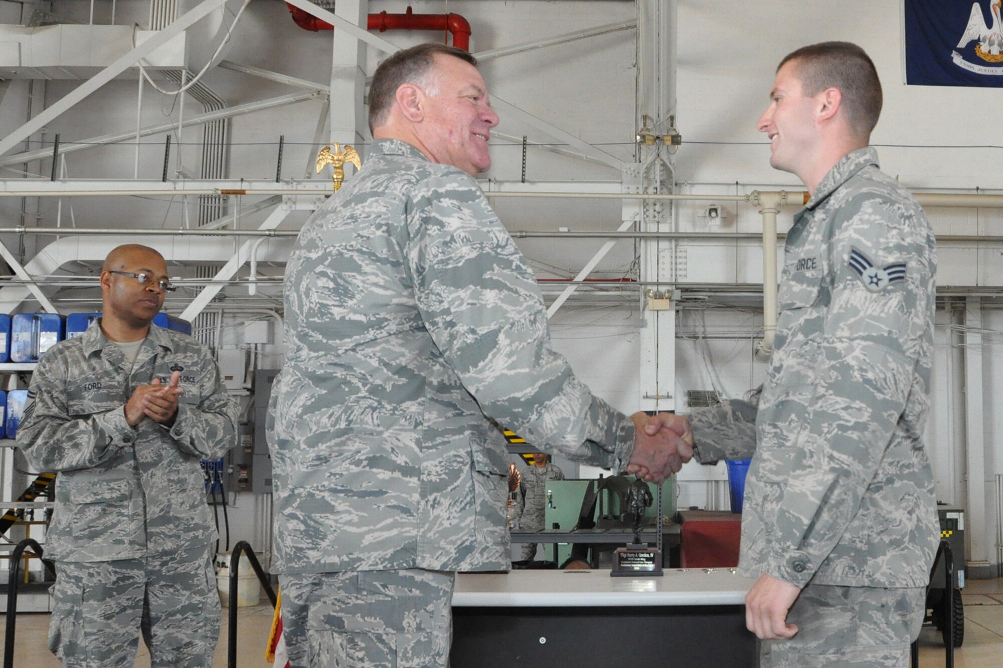U.S. Air Force Lt. Col. Leo Kamphaus, 307th Maintenance Group commander, congratulates Senior Airman Aaron Molina during a Commander’s Call on May 15, 2016, Barksdale Air Force Base, La. Molina is assigned to the 307th Maintenance Squadron and was awarded the 307th Bomb Wing’s Lieutenant General Leo Marquez Technician of the Year Award 2015 for demonstrating the job performance, efficiency, knowledge and Airmanship needed to be a well-rounded maintenance professional. (U.S. Air Force photo by Master Sgt. Greg Steele/Released)