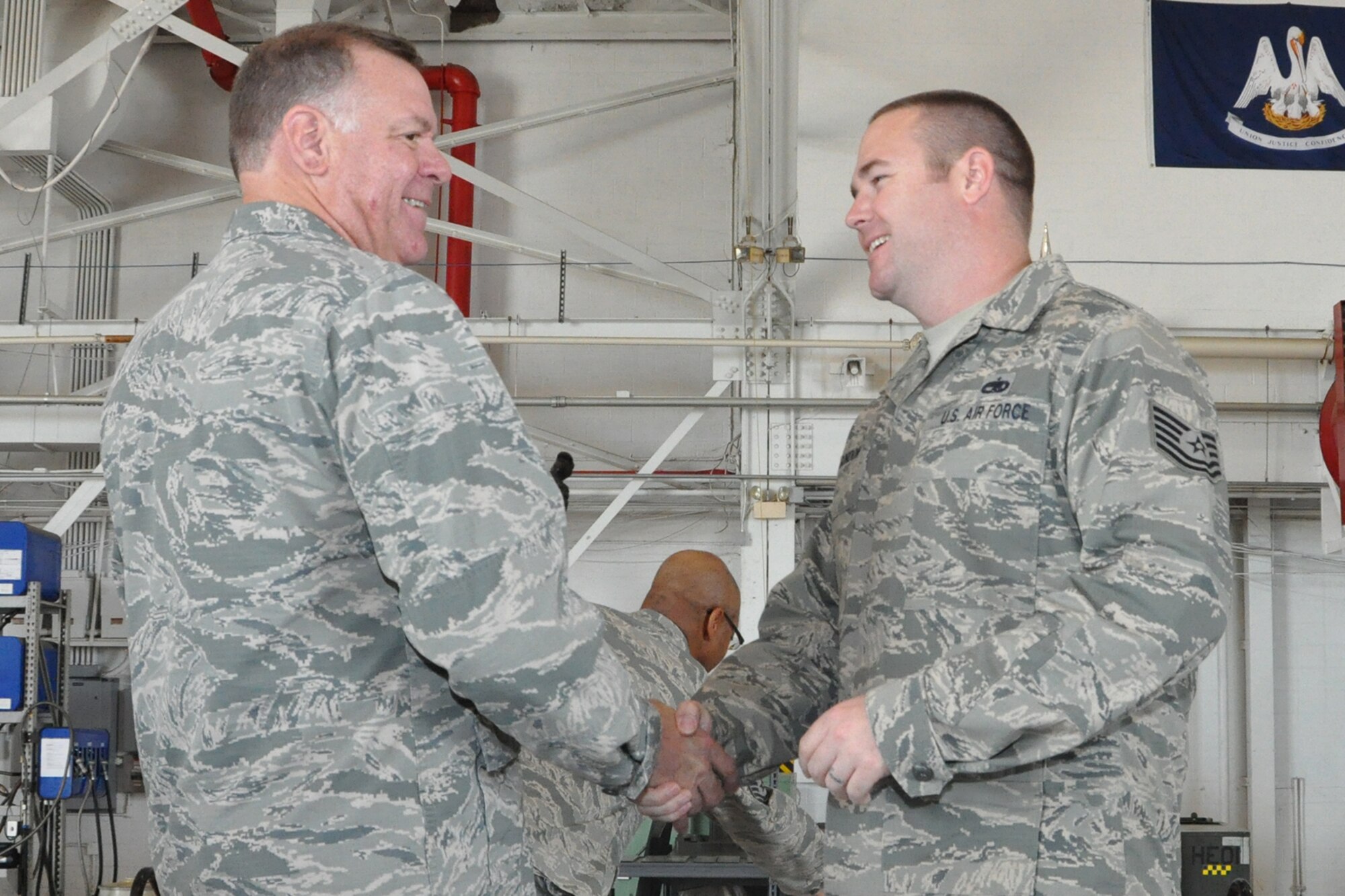 U.S. Air Force Lt. Col. Leo Kamphaus, 307th Maintenance Group commander, congratulates Tech. Sgt. Beau Gordon during a Commander’s Call on May 15, 2016, Barksdale Air Force Base, La. Gordon is assigned to the 307th Maintenance Squadron and was awarded the 307th Bomb Wing’s Lieutenant General Leo Marquez Technician Supervisor of the Year Award 2015 for demonstrating the job performance, efficiency, knowledge and Airmanship needed to be a well-rounded maintenance professional. (U.S. Air Force photo by Master Sgt. Greg Steele/Released)