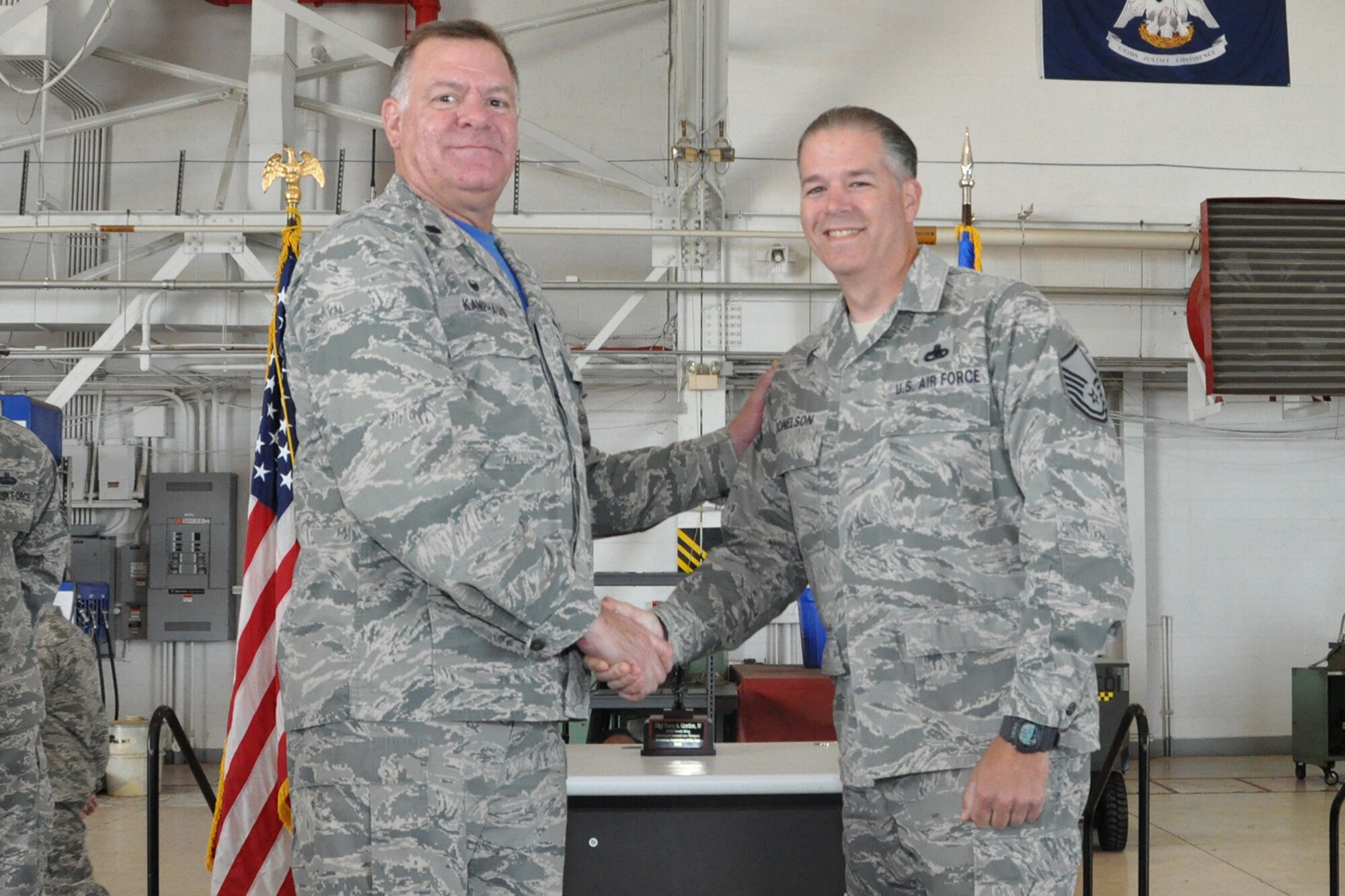 U.S. Air Force Lt. Col. Leo Kamphaus, 307th Maintenance Group commander, congratulates Master Sgt. John Donelson during a Commander’s Call on May 15, 2016, Barksdale Air Force Base, La. Donelson is assigned to the 307th Maintenance Squadron and was awarded the 307th Bomb Wing’s Lieutenant General Leo Marquez Supervisor Manager of the Year Award 2015 for demonstrating the job performance, efficiency, knowledge and Airmanship needed to be a well-rounded maintenance professional. (U.S. Air Force photo by Master Sgt. Greg Steele/Released)