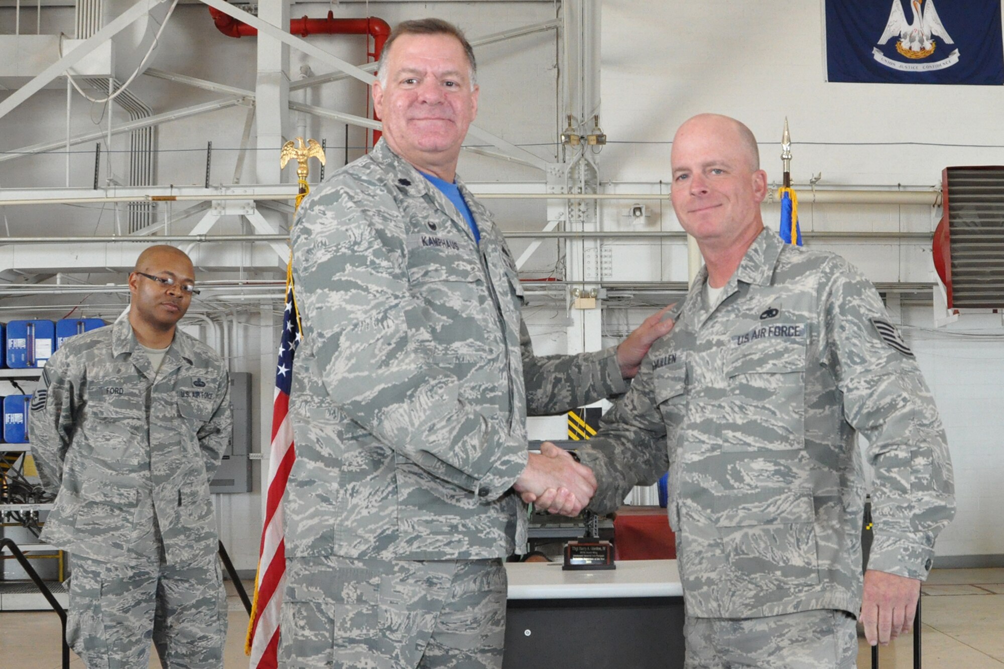 U.S. Air Force Lt. Col. Leo Kamphaus, 307th Maintenance Group commander, congratulates Tech. Sgt. Donald McMullen during a Commander’s Call on May 15, 2016, Barksdale Air Force Base, La. McMullen is assigned to the 307th Maintenance Squadron and was awarded the 307th Bomb Wing’s Lieutenant General Leo Marquez Civilian Manager of the Year Award 2015 for demonstrating the job performance, efficiency, knowledge and Airmanship needed to be a well-rounded maintenance professional. (U.S. Air Force photo by Master Sgt. Greg Steele/Released)