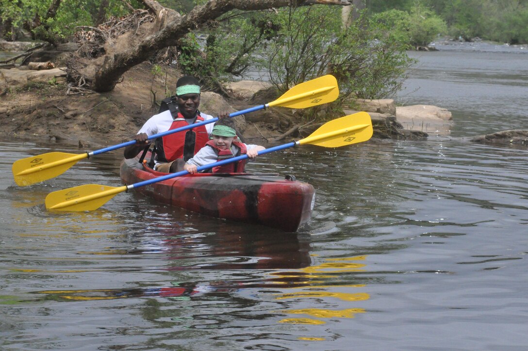 Lance Cpl. Bobby Magruder, big buddy, has fun canoeing with little buddy John Clark at Camp Rainbow recently.