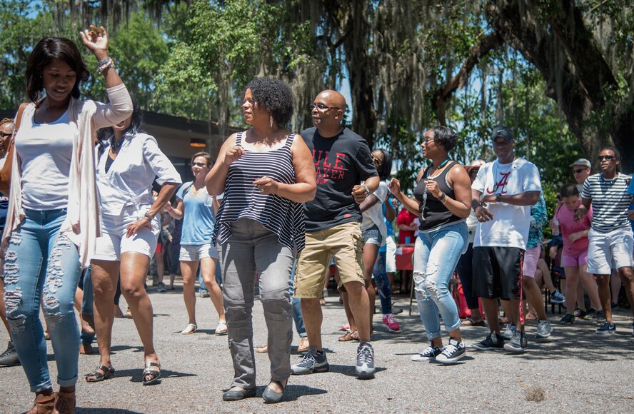 Airmen and family members dance during the Wing Spring Fling at Keesler Air Force Base, Mississippi, May 15, 2016. The purpose of the event is to allow leadership, Citizen Airmen, and their families a chance to interact and build camaraderie outside the work place. (U.S. Air Force photo/Staff Sgt. Shelton Sherrill)