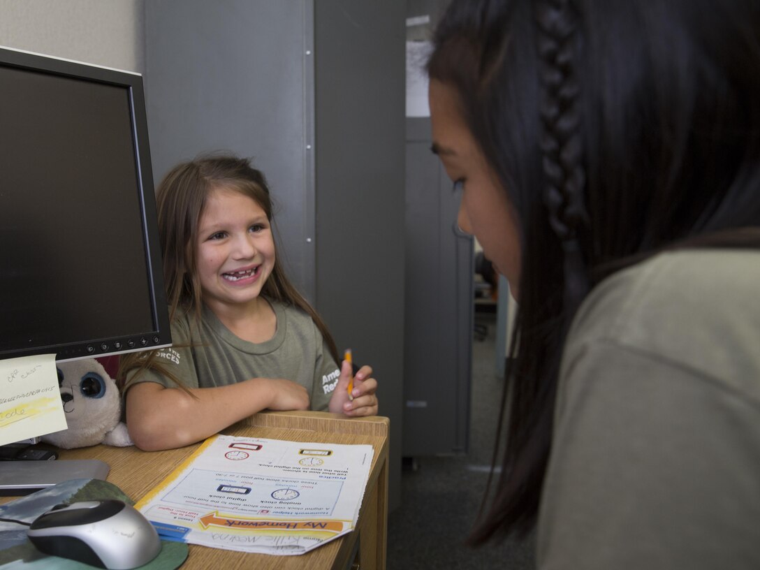 Marisol Gold, 11, chairwoman, American Red Cross Youth Club, helps Hollie Medina, 7, club member, with her homework during the ARYC’s Homework Helper Club at the Village Center May 5, 2016. The Homework Helper Club provides students with a supportive learning environment every Thursday at 5 p.m. (Official Marine Corps photo by Cpl. Connor Hancock/Released)