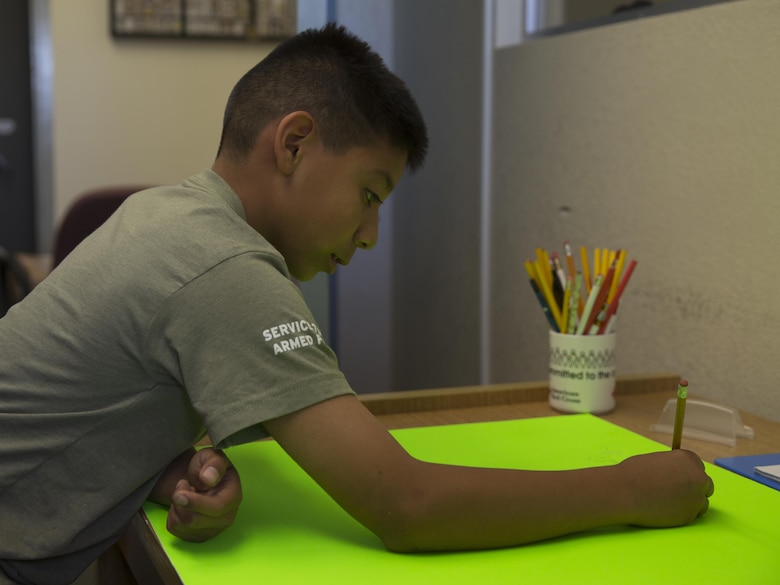 Amadeus Martinez, 11, club member, American Red Cross Youth Club, creates a sign for the ARCYC Bake Sale at the Combat Center’s Village Center May 5, 2016. The Homework Helper Club provides students with a supportive learning environment every Thursday at 5 p.m. (Official Marine Corps photo by Cpl. Connor Hancock/Released)