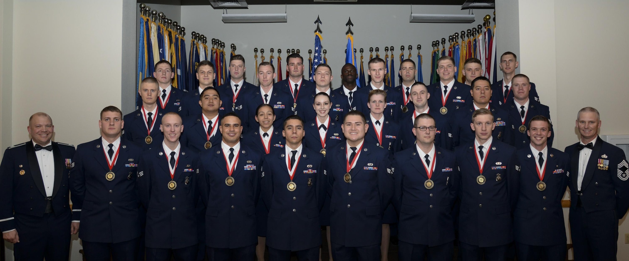 Col. Matthew Dillow, 90th Missile Wing vice commander, and Chief Master Sgt. John Facemire, 90th Mission Support Group chief enlisted manager, pose with the graduating Airman Leadership School Class 13-E students in the Trail's End Event Center on F.E. Warren Air Force Base, Wyo., May 18, 2016. Enlisted Airmen must complete the rigorous professional military education course to become supervisors of other Airmen. (U.S. Air Force photo by Senior Airman Jason Wiese)