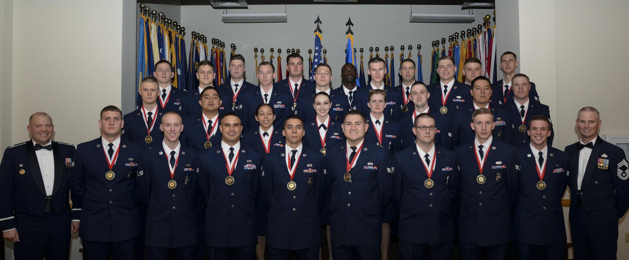 Col. Matthew Dillow, 90th Missile Wing vice commander, and Chief Master Sgt. John Facemire, 90th Mission Support Group chief enlisted manager, pose with the graduating Airman Leadership School Class 13-E students in the Trail's End Event Center on F.E. Warren Air Force Base, Wyo., May 18, 2016. Enlisted Airmen must complete the rigorous professional military education course to become supervisors of other Airmen. (U.S. Air Force photo by Senior Airman Jason Wiese)