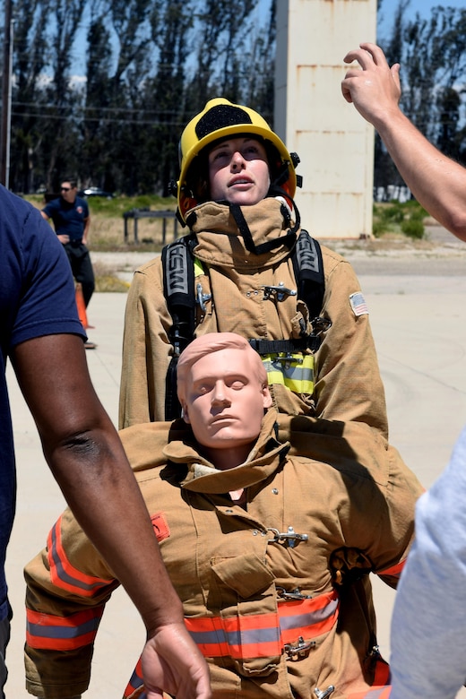1st Lt. Morgan Grohol, 30th Mission Support Group executive officer, maneuvers a dummy through an obstacle as part of a firefighter immersion event, May 18, 2016, Vandenberg Air Force Base, Calif. The immersion was intended to give junior officers in the CES a better understanding of Vandenberg’s Fire Department, and began with an in-depth briefing followed by the opportunity to experience an obstacle course, known as the Firefighter Combat Challenge. (U.S. Air Force photo by Staff Sgt. Shane Phipps/Released)