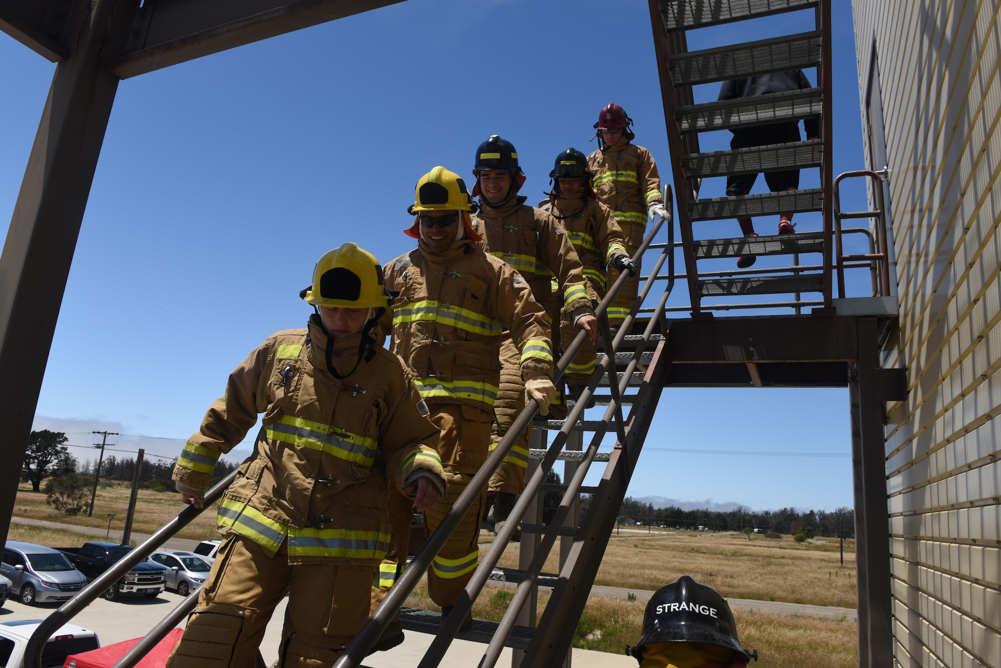 Company Grade Officers from the 30th Civil Engineer Squadron descend a staircase during a firefighter immersion event, May 18, 2016, Vandenberg Air Force Base, Calif. The immersion was intended to give junior officers in the CES a better understanding of Vandenberg’s Fire Department, and began with an in-depth briefing followed by the opportunity to experience an obstacle course, known as the Firefighter Combat Challenge. (U.S. Air Force photo by Staff Sgt. Shane Phipps/Released)
