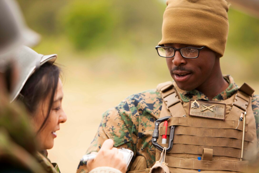 Sgt. Kenyun Scott discusses the specifications of a M777 Lightweight Towed Howitzer during artillery demonstration and community outreach for Artillery Relocation Training Program 16-1, in Senjogahara, Japan, May 16, 2016. ARTP is a Japan-funded, routine training exercise that allows Marines with 3rd Battalion, 12th Marine Regiment, 3rd Marine Division, III Marine Expeditionary Force, based out of Camp Hansen, Okinawa, Japan, to conduct live-fire training. Scott, a Mansfield, La., native and section chief with 3rd Bn., 11th Marine Regiment, 1st MarDiv, I MEF, is currently attached to 3rd Bn., 12th Marines.