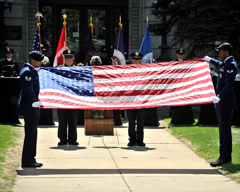 Staff Sgt. Alonzo Clark, left, and Senior Airman Eric Bailey, right, 319th Security Forces Squadron, perform the flag folding ceremony during the National Police Week Memorial Service at Grand Forks County Court House on May 17, 2016, in Grand Forks, N.D. The memorial service is to honor those that have paid the ultimate sacrifice during their line of duty. (U.S. Air Force photo/Senior Airman Xavier Navarro)