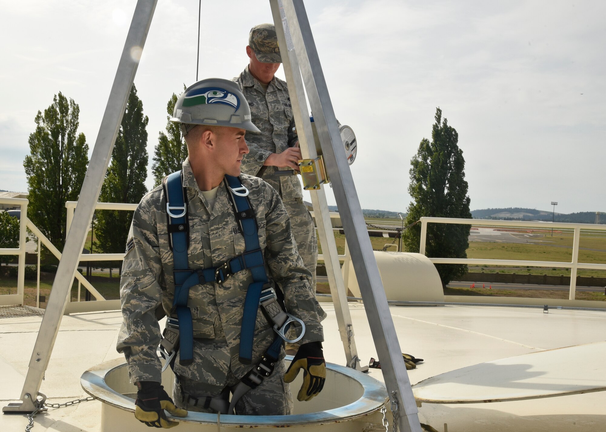 Senior Airman Phillip Wise, 92nd Civil Engineer Squadron water and fuels system maintenance technician, waits as Staff Sgt. Steven Strand, 92nd CES water and fuels system maintenance technician, adjusts cables before being hoisted down a fuel tank May 4, 2016, at Fairchild Air Force Base, Wash. Air Force Occupational Safety sponsored Fall Protection Focus weeks during the month of May to draw attention to avoidable mishaps due to falls. During calendar years 2011-2015, falls were responsible for 6,724 Air Force injuries that resulted in 42,539 lost work days and a cost of nearly $65 million. (U.S. Air Force photo/Airman 1st Class Taylor Bourgeous)