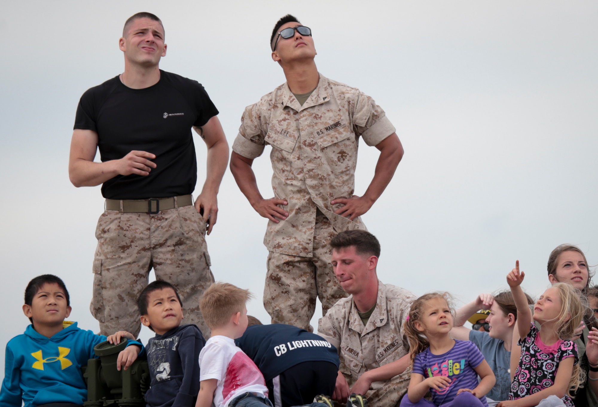 U.S. Marines and children watch the U.S. Air Force Thunderbirds take off during the Power in the Pines Open House and Air Show on Joint Base McGuire-Dix-Lakehurst, N.J., May 14, 2016. (U.S. Air National Guard photo by Tech. Sgt. Matt Hecht/Released)