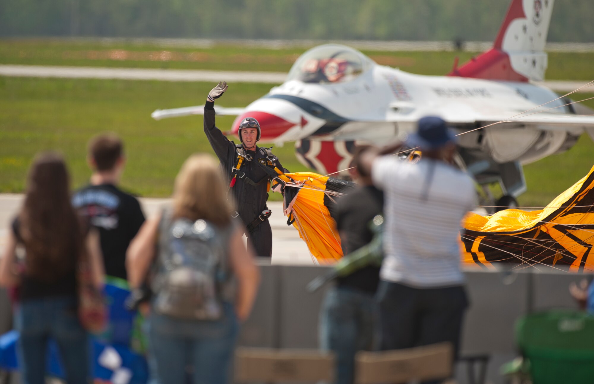 A U.S. Army Golden Knight parachuter waves to the crowd after landing atthe Power in the Pines Open House and Air Show at Joint Base McGuire-Dix-Lakehurst, N.J. May 14. As the nation???s only tri-service joint base, JB MDL???s Power in the Pines Open House and Air Show boasts demonstrations from each branch of the armed forces. (U.S. Air Force photo by Christian DeLuca/released)