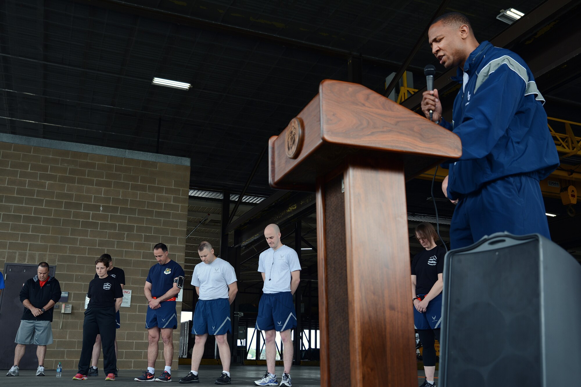 Chaplain (Capt.) Thomas Simmons, Team McChord Chaplain, offers a prayer before the 62nd Aerial Port Squadron 5K Memorial Run May 18, 2016, on Joint Base Lewis-McChord, Wash. This year’s run marked the third consecutive year that aerial porters, known as port dawgs, from around the Air Force ran to honor fallen port dawgs. (U.S. Air Force photo/Senior Airman Jacob Jimenez) 