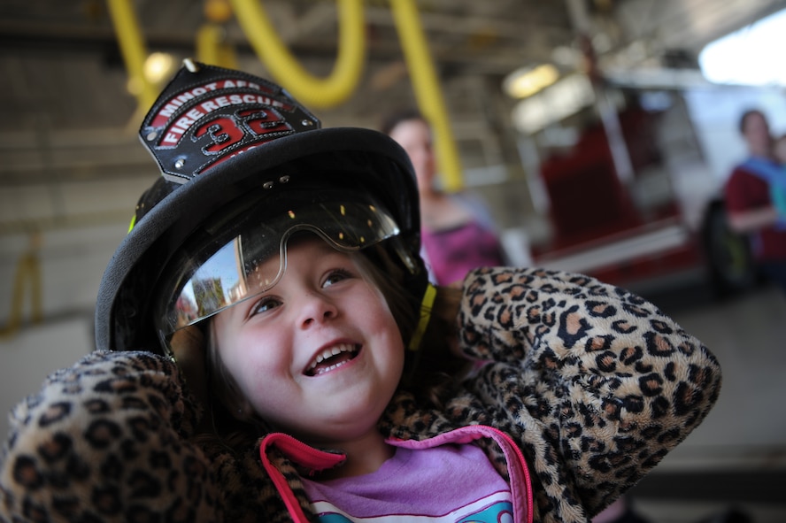 Maise Janovich, Minot Air Force Base resident, at the Minot AFB fire department on Minot AFB, N.D. May 16, 2016. Janovich is part of the Minot AFB Co-op which is a group of parents that meet together weekly to teach their kids various school subjects and visited the fire department which was part of several last day events before taking a summer hiatus. (U.S. Air Force photo by Staff Sgt. Chad Trujillo)