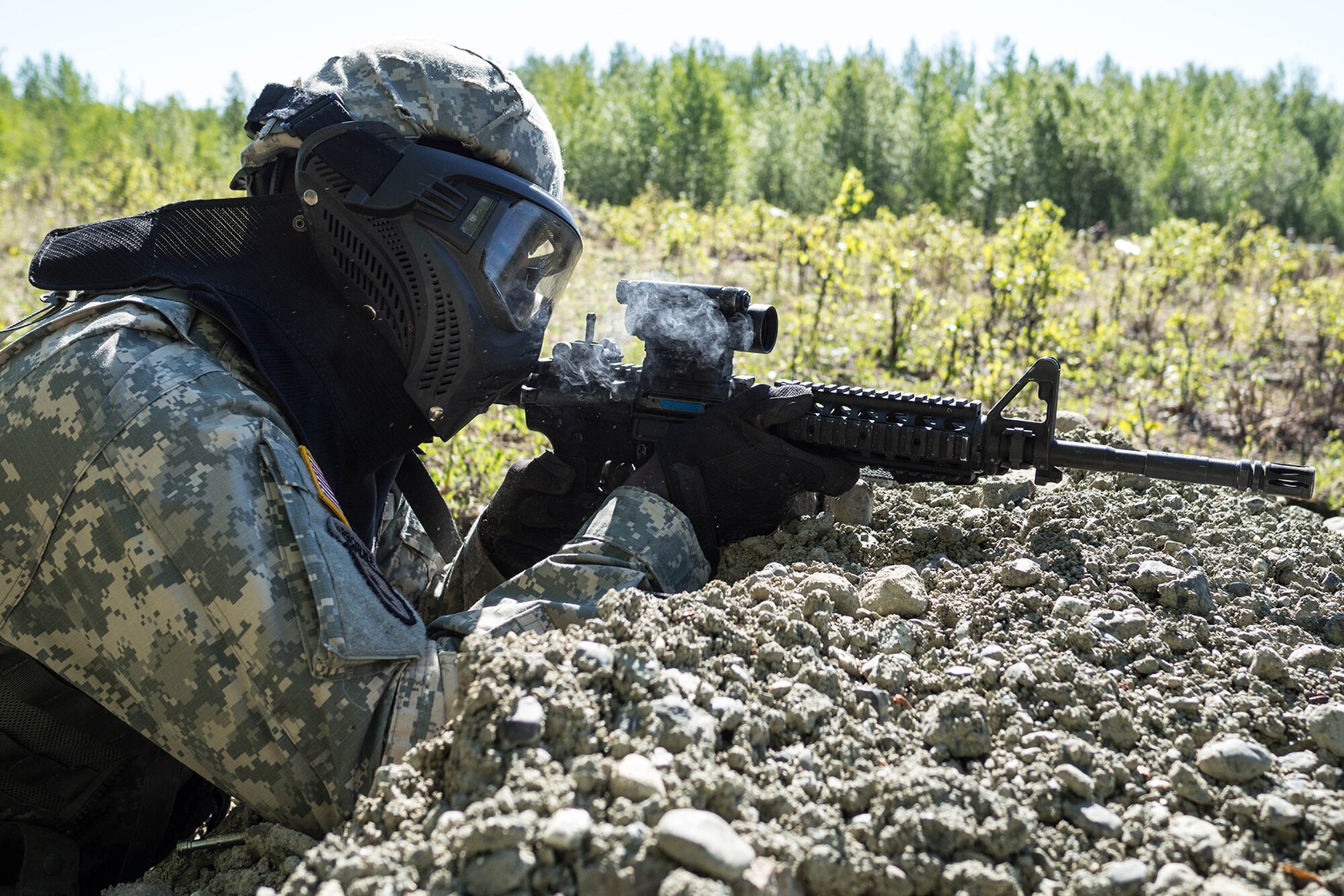 Alaska Army National Guard Spc. Innocent Bennett, B Company, 1st Battalion (Airborne), 143rd Infantry Regiment, engages opposing forces during an individual-movement techniques lane May 14, 2016, at the Alaska National Guard's Alcantra Armory in Wasilla. Soldiers used paint-marking training rounds to up the stakes for the training that is usually conducted using laser-based training devices. (U.S. Army National Guard photo by Sgt. David Bedard)