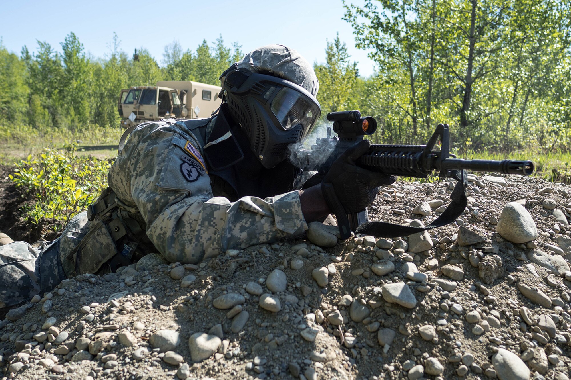 Alaska Army National Guard Spc. Innocent Bennett, B Company, 1st Battalion (Airborne), 143rd Infantry Regiment, engages opposing forces during an individual-movement techniques lane May 14, 2016, at the Alaska National Guard's Alcantra Armory in Wasilla. Soldiers used paint-marking training rounds to up the stakes for the training that is usually conducted using laser-based training devices. (U.S. Army National Guard photo by Sgt. David Bedard)