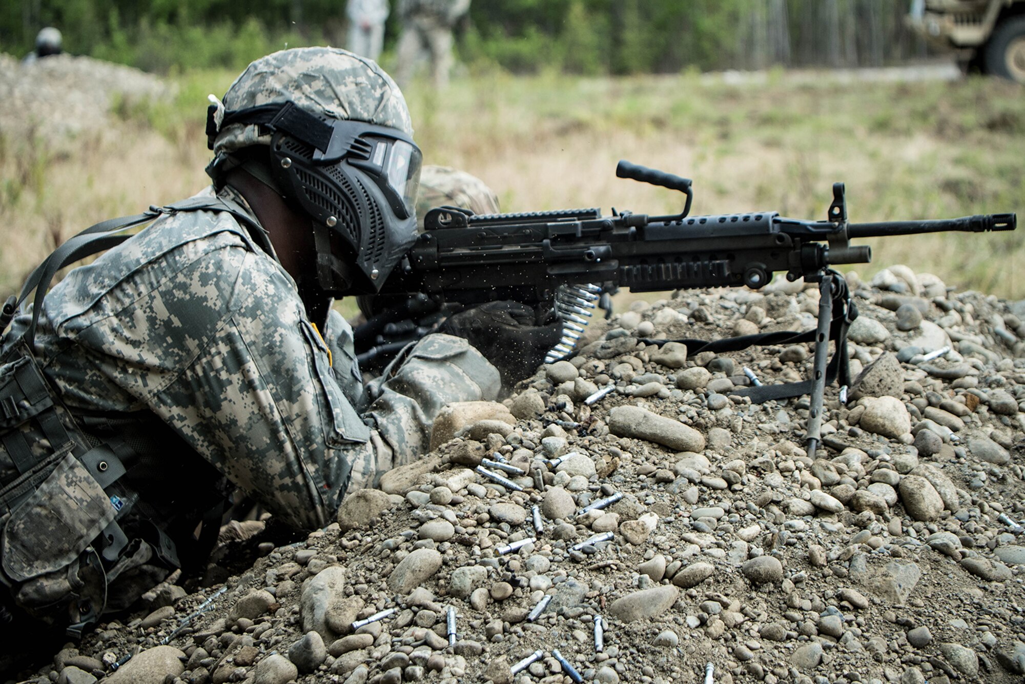 Alaska Army National Guard Spc. Innocent Bennett, B Company, 1st Battalion (Airborne), 143rd Infantry Regiment, engages opposing forces during an individual-movement techniques lane May 14, 2016, at the Alaska National Guard's Alcantra Armory in Wasilla. Soldiers used paint-marking training rounds to up the stakes for the training that is usually conducted using laser-based training devices. (U.S. Army National Guard photo by Sgt. David Bedard)