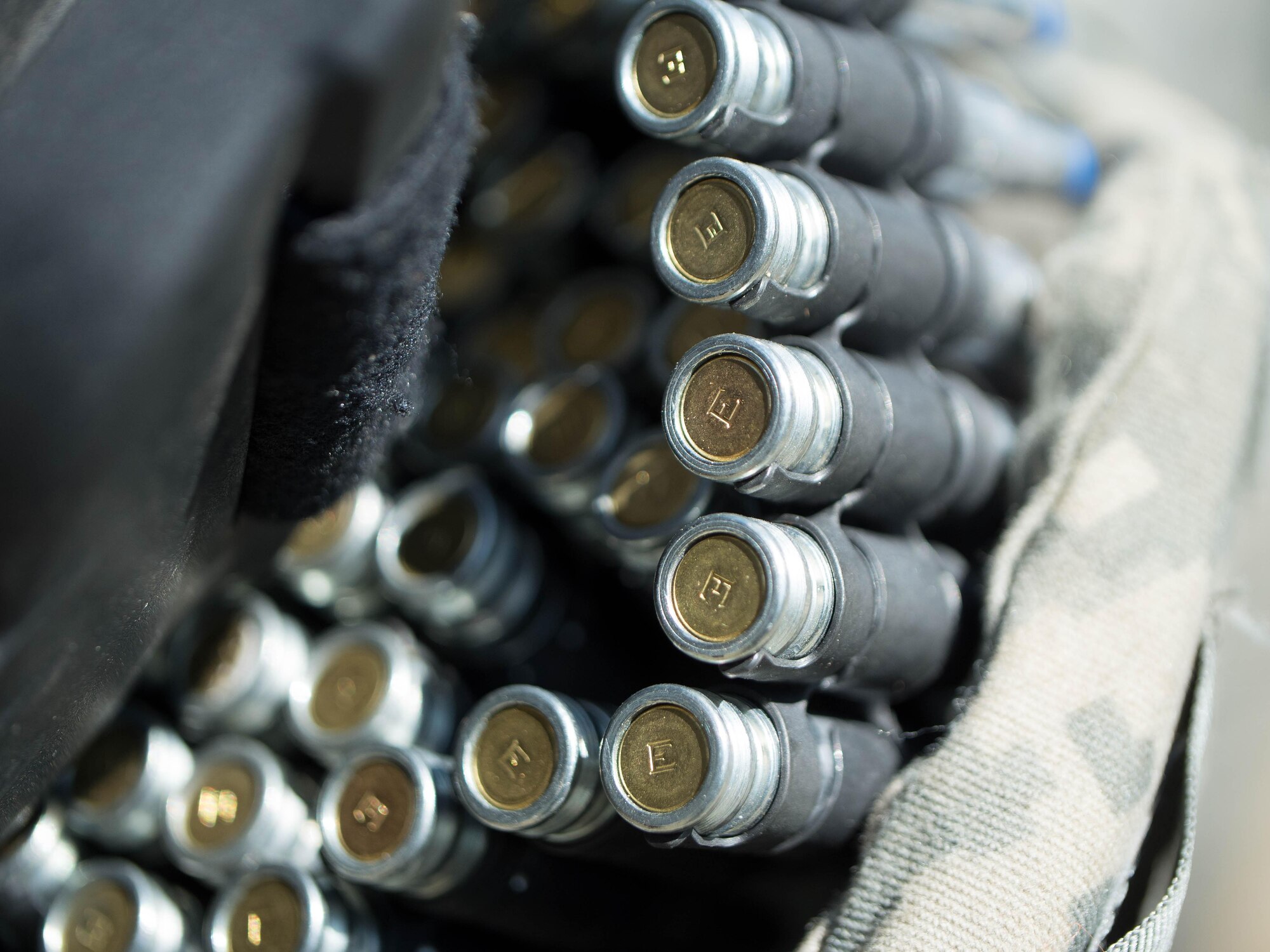 Paint-marker training munitions for a squad-automatic weapon rest in a helmet May 14, 2016, at the Alaska National Guard's Alcantra Armory in Wasilla. The munitions were used for individual-movement techniques training. The rimfire munition uses a unique bolt to ensure no live ammunition can be fired. (U.S. Army National Guard photo by Sgt. David Bedard)