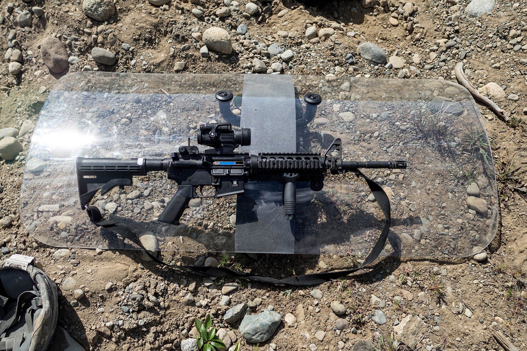 An M-4 Carbine and a riot shield rest May 14, 2016, at the Alaska National Guard's Alcantra Armory in Wasilla. Observer controllers used the shields to protect themselves from paint-marker training munitions fired during individual-movement techniques training. (U.S. Army National Guard photo by Sgt. David Bedard)