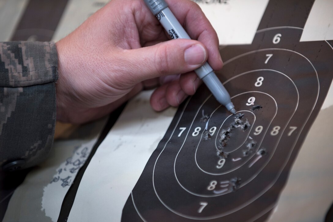 Tech. Sgt. Gregg Moseley, 11th Security Support Squadron combat arms training and maintenance instructor, marks shots during the 2016 Elementary Level Excellence in Competition Rifle Match at Joint Base Andrews, Md., May 17. The top ten percent of competitors in the EIC receive a uniform badge. (U.S. Air Force photo by Airman 1st Class Philip Bryant) 