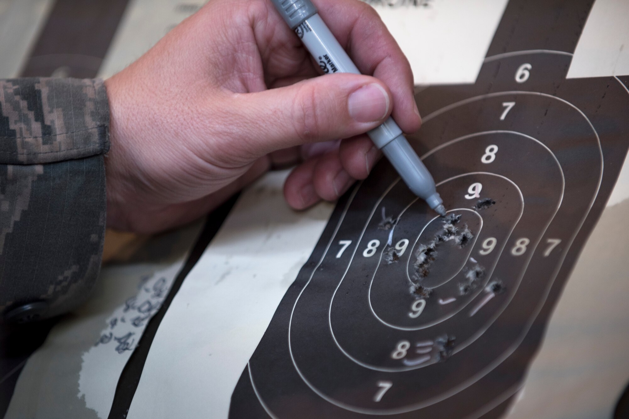 Tech. Sgt. Gregg Moseley, 11th Security Support Squadron combat arms training and maintenance instructor, marks shots during the 2016 Elementary Level Excellence in Competition Rifle Match at Joint Base Andrews, Md., May 17. The top ten percent of competitors in the EIC receive a uniform badge. (U.S. Air Force photo by Airman 1st Class Philip Bryant) 
