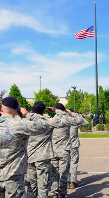 Airmen with the 341st Security Forces Group salute during a retreat ceremony May 16, 2016, at Malmstrom Air Force Base, Mont. Malmstrom held the retreat honoring National Police Week, as well as a shooting competition between Airmen and local law enforcement, a spouse’s immersion and a static display. (U.S. Air Force photo/Airman 1st Class Magen M. Reeves)

