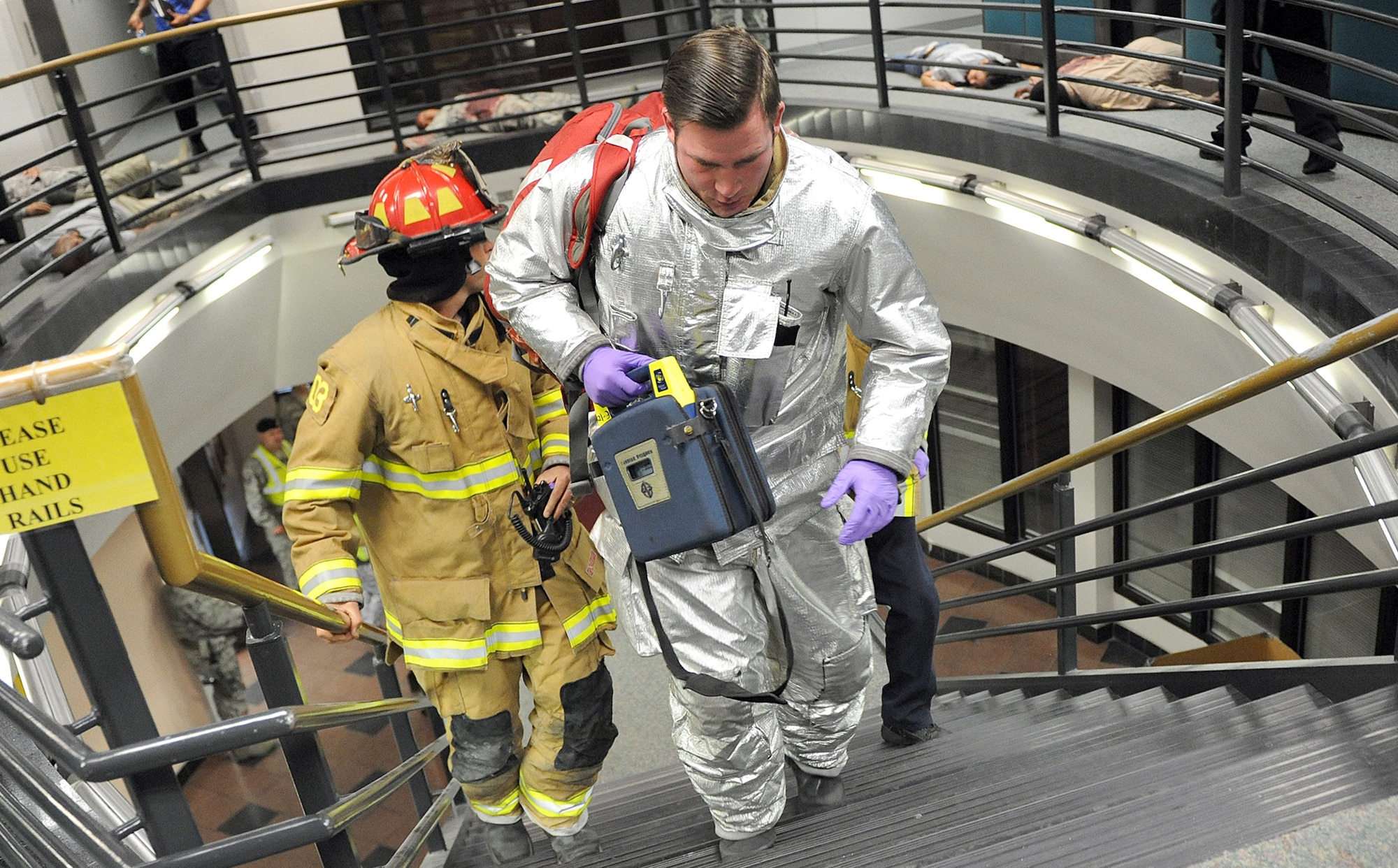 Team Robins conducted a series of exercises last week which included an active-shooter scenario involving airmen who were moulaged to portray victims. Shown here, Emergency personnel make their way up the steps to assist first responders. (U.S. Air Force photo by Tommie Horton)