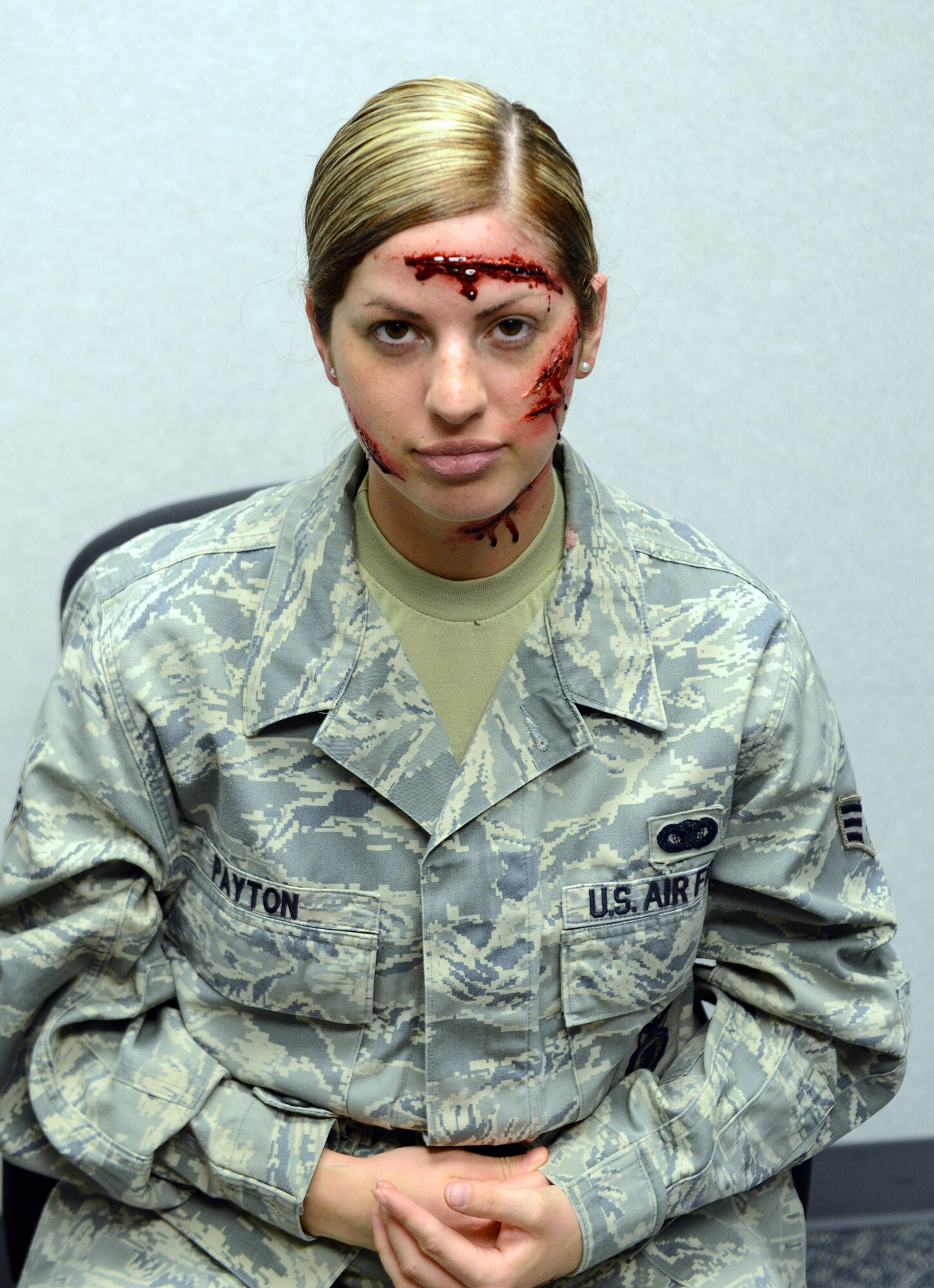 Senior Airman Shawnee Ryan, 78th Medical Support Squadron laboratory technician, shows off her moulage makeover. The name on her uniform is different because it's used for exercises. (U.S. Air Force photo by Tommie Horton)