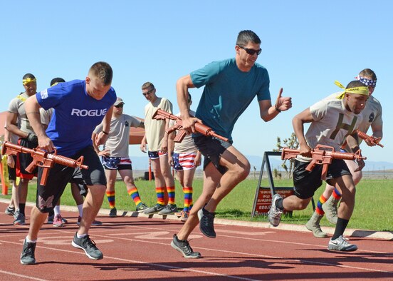 Defenders from the 412th Security Forces Squadron take off on the first lap of a relay race May 19. The relay race was the opening event of the Defender Olympics held during National Police Week. (U.S. Air Force photo by Kenji Thuloweit) 
