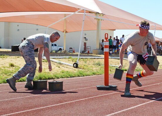 Airmen from the 412th Security Forces Squadron sprint to pick up full ammunition cans during a shuttle run May 19 as part of the Defender Olympics. (U.S. Air Force photo by Kenji Thuloweit) 