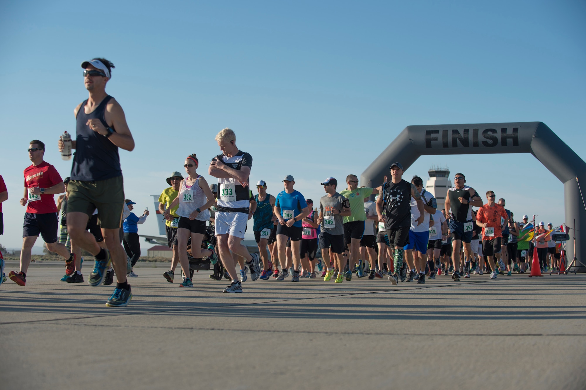 Runners begin their journey across the Edwards Air Force Base flightline and Rogers Dry Lake during the second annual Run with History here Saturday. More than 400 people signed up to run either the half-marathon, the 10-kilometer, or the 5-kilometer courses. (U.S. Air Force photo by Ethan Wagner.)