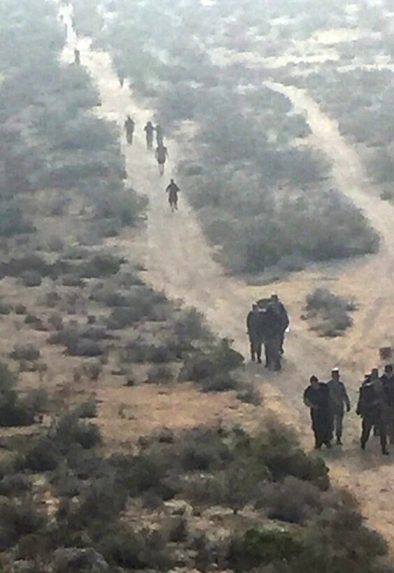Marchers near the halfway point during 14-kilometer ruck march here Tuesday. The march was held as part of Police Week observances. Each kilometer represents a fallen Air Force Security Forces member. (Photo by Pamela Vallely.)